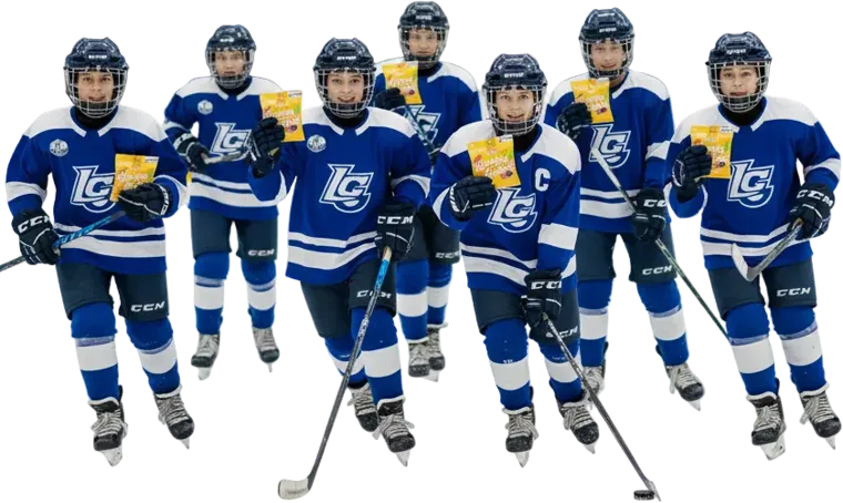 A youth hockey team in blue jerseys, each holding a bag of Gummy Gainz Fruit Salad gummies